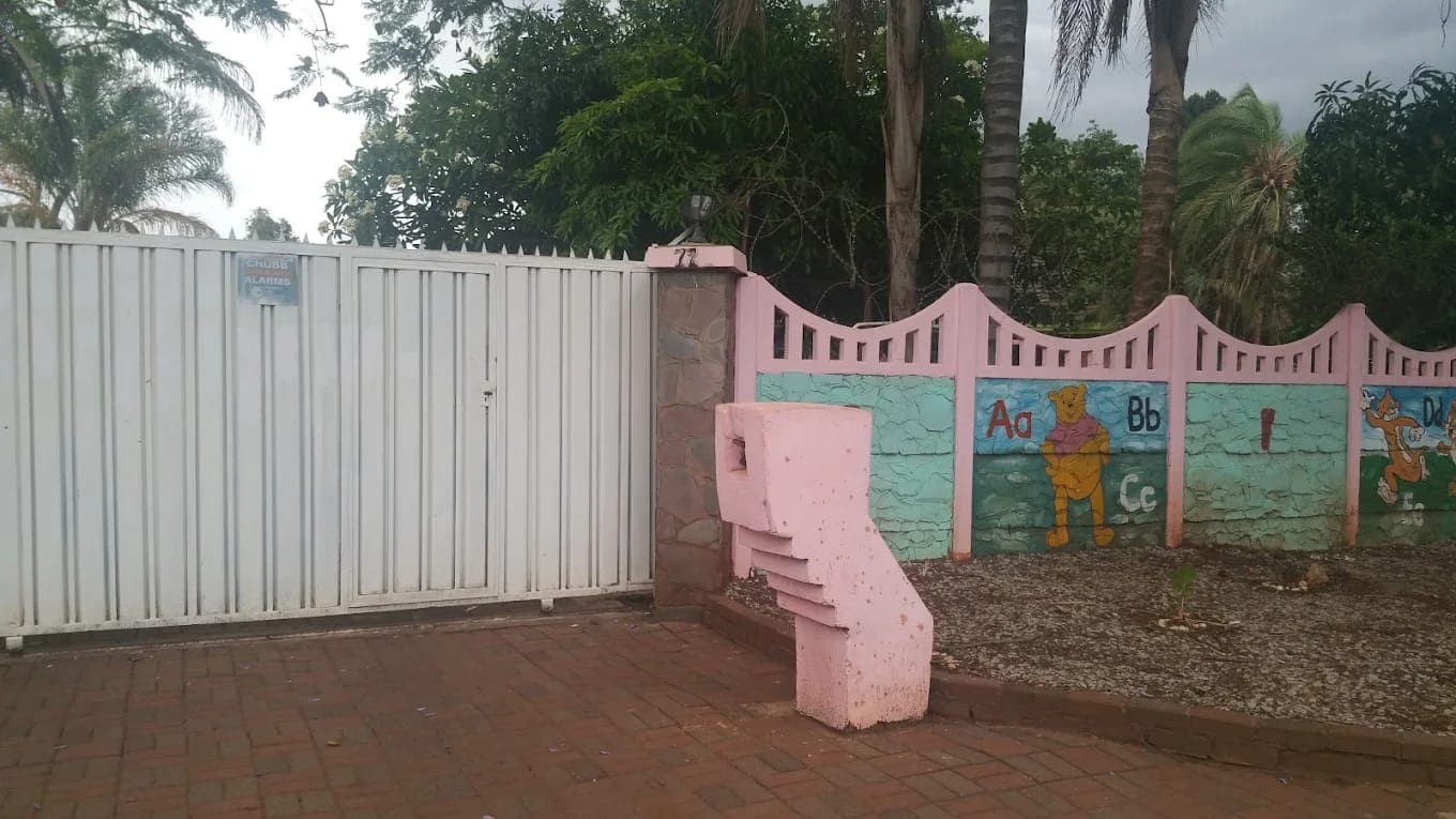 The gate of Nirmeen Nursery & Junior School at 72 Eastcourt Rd, Belvedere, Harare, beside its painted alphabet wall